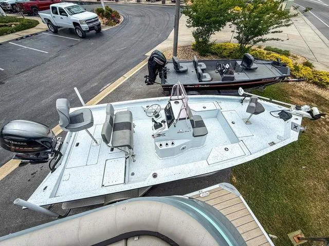 Slide: The Image of 2022 Xpress Boats H20B fishing boat with Yamaha motor in a parking lot. - 3