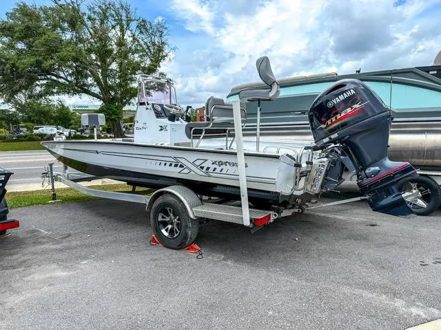 Slide: The Image of 2022 Xpress Boats H20B on trailer with Yamaha outboard motor, parked outdoors. - 5