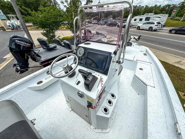 Slide: The Image of 2022 Xpress Boats H20B center console with steering wheel and navigation display. - 8