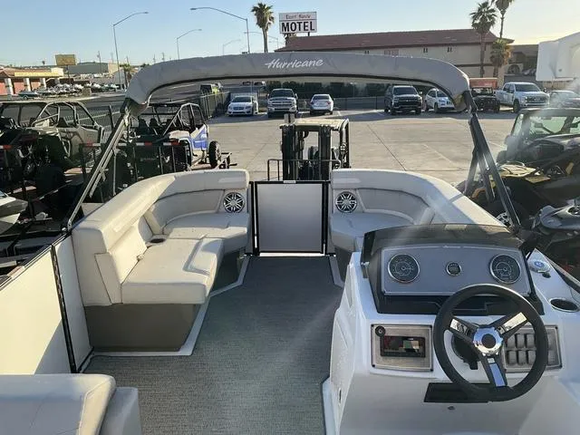 Slide: The Image of 2023 Hurricane FunDeck 2260 REF OB boat with spacious seating and modern dashboard. - 12