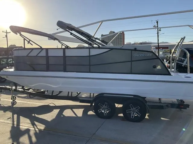 Slide: The Image of 2023 Hurricane FunDeck 2260 REF OB boat on trailer, parked outdoors at sunset. - 8