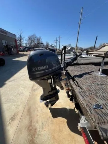 Slide: The Image of 2025 Xpress Boats HD 16 DB with Yamaha outboard motor, parked outdoors. - 10