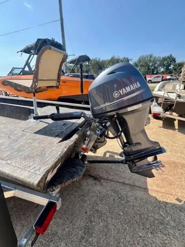 Slide: The Image of 2025 Xpress Boats HD 16 DB with Yamaha outboard motor, parked outdoors. - 5