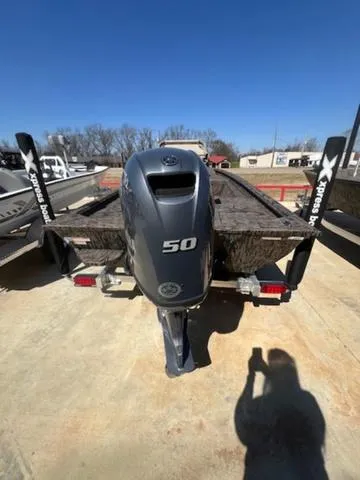 Slide: The Image of 2025 Xpress Boats HD 16 DB with 50 HP engine, parked outdoors. - 9