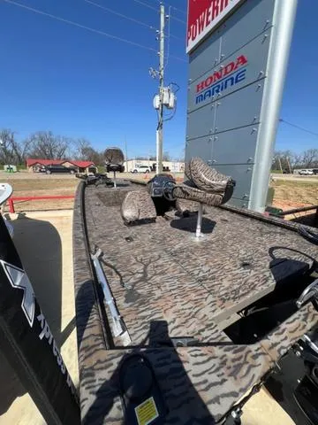 Slide: The Image of 2025 Xpress Boats XP180 with camouflage design, displayed outdoors near Honda Marine sign. - 12