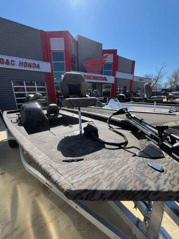 Slide: The Image of 2025 Xpress Boats XP180 at dealership, featuring camouflage design and modern equipment. - 9