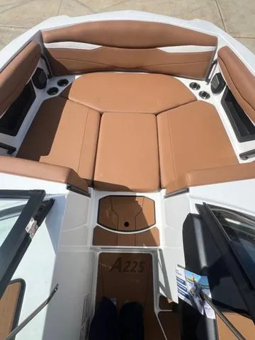 Slide: The Image of 2025 Axis Wake Research A225 boat interior with tan seating and modern design. - 12