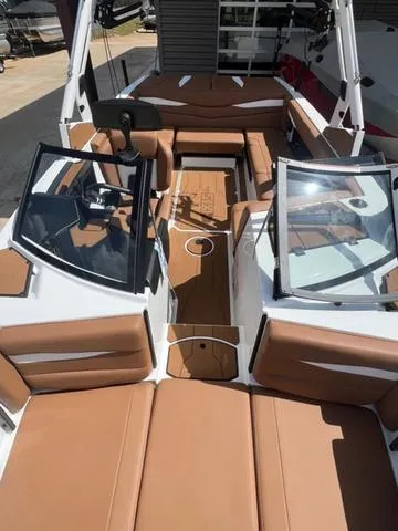 Slide: The Image of 2025 Axis Wake Research A225 boat interior with tan seating and sleek design. - 13
