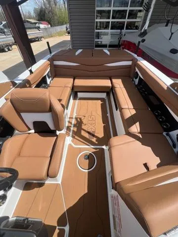 Slide: The Image of 2025 Axis Wake Research A225 boat interior with brown seating and modern design. - 14