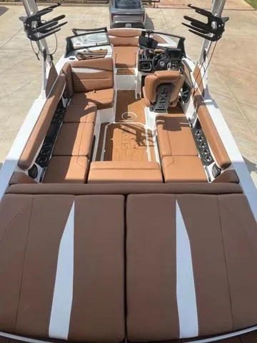Slide: The Image of 2025 Axis Wake Research A225 boat interior with brown and white seating. - 9