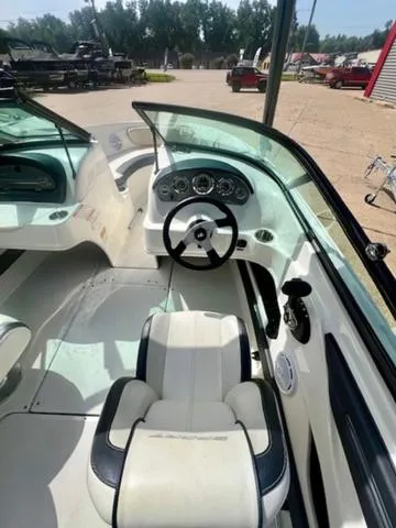 Slide: The Image of 2012 Sea Ray 205 Sport boat interior with steering wheel and dashboard. - 3