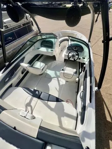 Slide: The Image of 2012 Sea Ray 205 Sport boat interior with seating and steering wheel. - 4