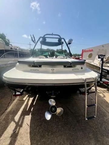 Slide: The Image of 2012 Sea Ray 205 Sport boat, rear view, with ladder and propeller, parked outdoors. - 5