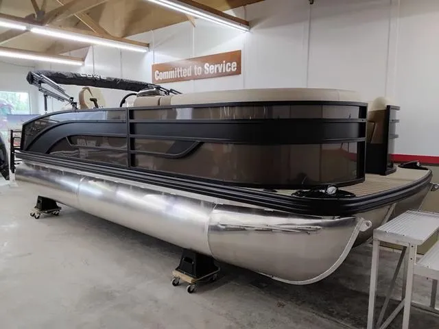 Slide: The Image of 2025 Lowe SS 210 TL pontoon boat in showroom, showcasing sleek design and modern features. - 1