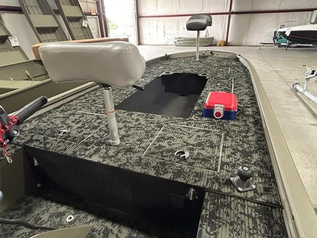 Slide: The Image of 2023 Tracker GRIZZLY® 1648 MVX boat interior with camo deck and seating. - 3