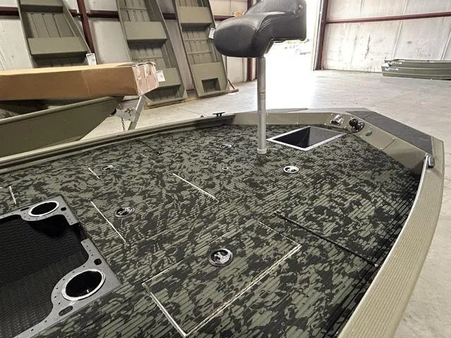 Slide: The Image of 2023 Tracker GRIZZLY® 1648 MVX boat interior with camo deck and swivel seat. - 4