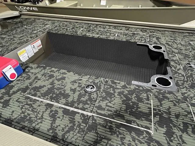 Slide: The Image of 2023 Tracker GRIZZLY® 1648 MVX boat interior with camo pattern and storage compartment. - 5