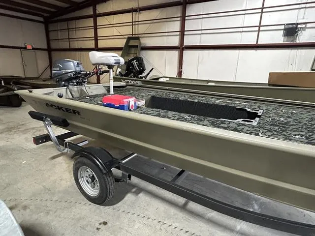 Slide: The Image of 2023 Tracker GRIZZLY® 1648 MVX boat in warehouse, on trailer, with motor and equipment. - 6