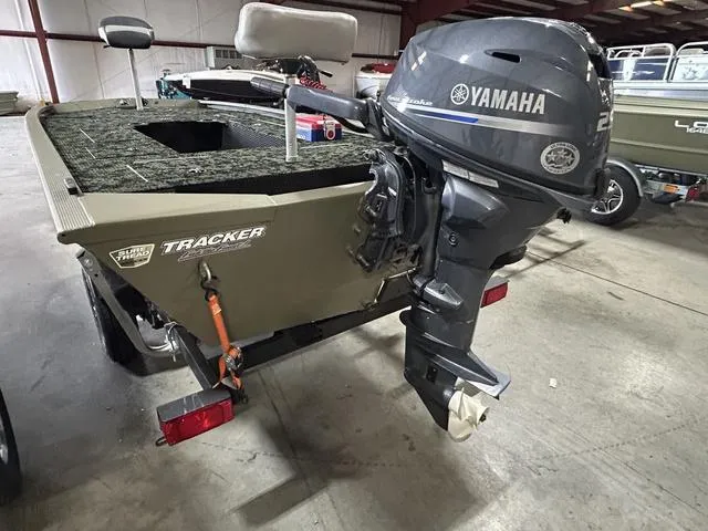 Slide: The Image of 2023 Tracker GRIZZLY® 1648 MVX boat with Yamaha outboard motor in a warehouse setting. - 7