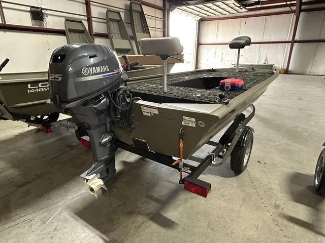 Slide: The Image of 2023 Tracker GRIZZLY® 1648 MVX boat with Yamaha 25 engine in a warehouse. - 8
