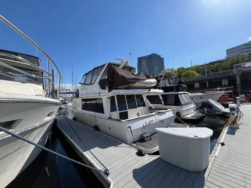 Slide: The Image of 1996 Bayliner 4788 yacht docked at marina under clear blue sky. - 10