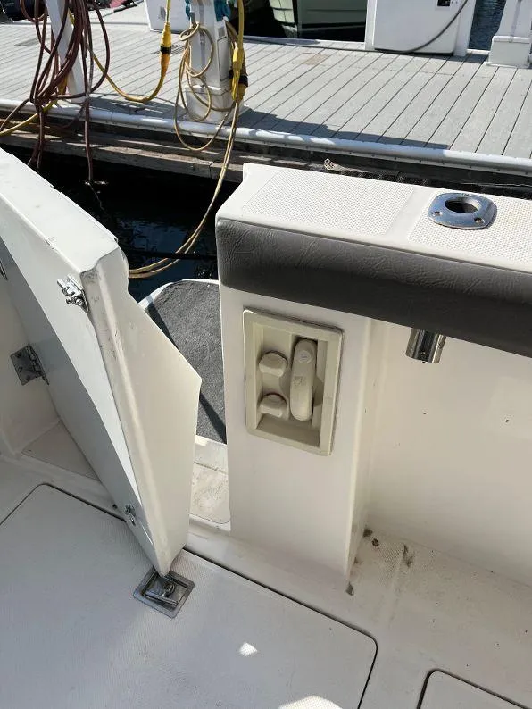 Slide: The Image of 1996 Bayliner 4788 yacht deck with open hatch and control panel. - 14