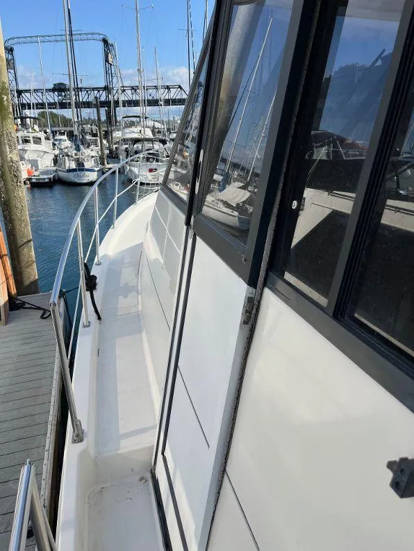 Slide: The Image of 1996 Bayliner 4788 yacht docked at marina with clear blue sky. - 18