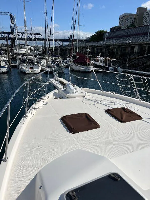 Slide: The Image of 1996 Bayliner 4788 yacht docked in marina, surrounded by other boats. - 20