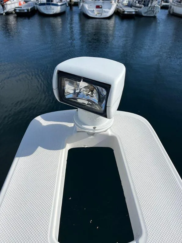 Slide: The Image of Close-up of a 1996 Bayliner 4788 spotlight on a boat deck in a marina. - 22