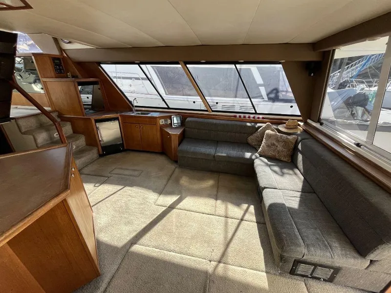 Slide: The Image of Spacious interior of 1996 Bayliner 4788 yacht with plush seating and large windows. - 27