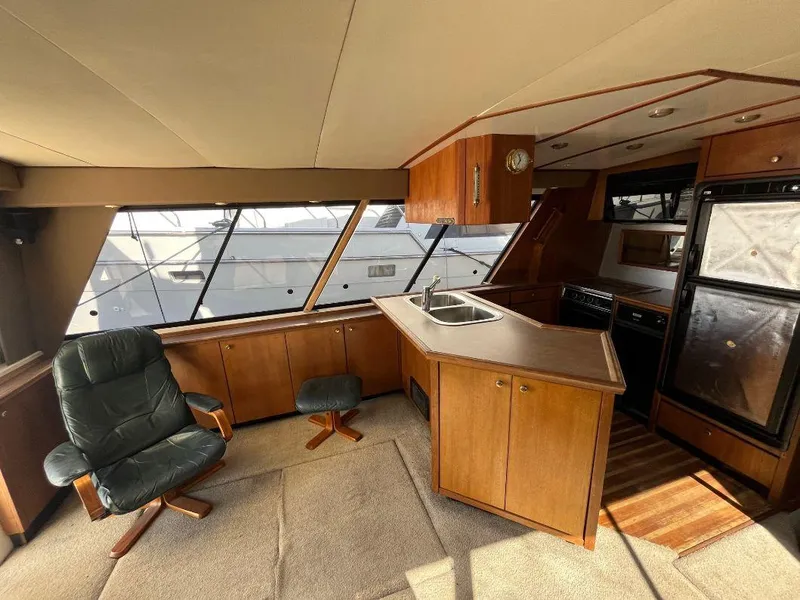 Slide: The Image of Interior of a 1996 Bayliner 4788 yacht with kitchen and seating area. - 29