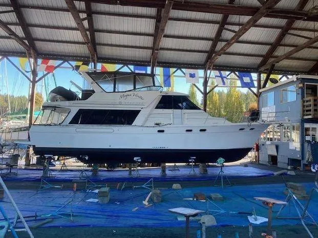 Slide: The Image of 1996 Bayliner 4788 yacht in dry dock under a covered marina. - 3