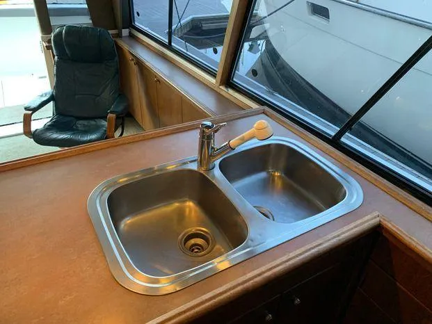 Slide: The Image of Stainless steel sink in 1996 Bayliner 4788 yacht kitchen area. - 32