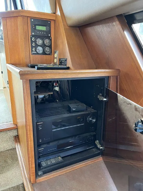 Slide: The Image of 1996 Bayliner 4788 yacht interior with electronic equipment cabinet and control panel. - 35