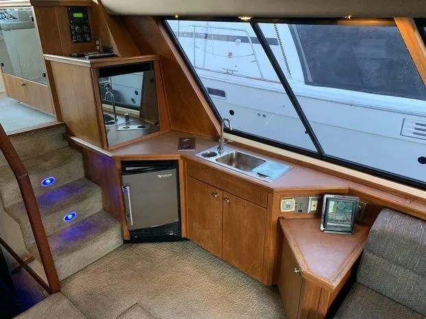 Slide: The Image of Interior of a 1996 Bayliner 4788 yacht with kitchenette and stairs. - 38