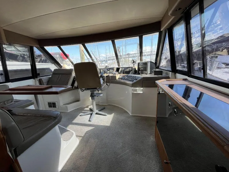 Slide: The Image of Interior of 1996 Bayliner 4788 yacht with helm station and seating area. - 39