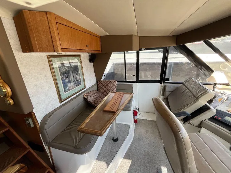 Slide: The Image of Interior of 1996 Bayliner 4788 yacht with seating, table, and helm station. - 42