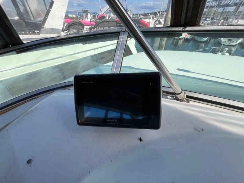Slide: The Image of 1996 Bayliner 4788 helm with Garmin navigation display, docked at marina. - 46