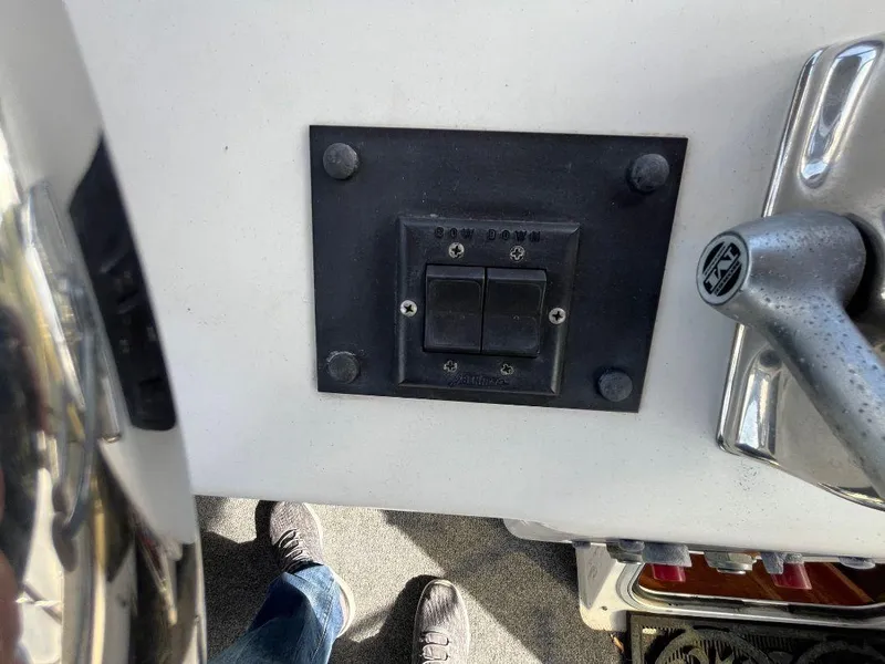 Slide: The Image of Control panel on a 1996 Bayliner 4788 yacht, featuring switches and a throttle lever. - 48