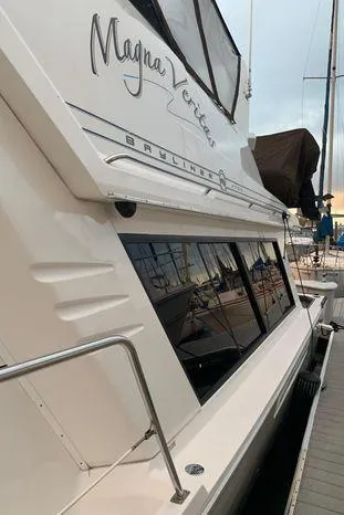 Slide: The Image of 1996 Bayliner 4788 yacht docked, showcasing sleek design and elegant exterior. - 6