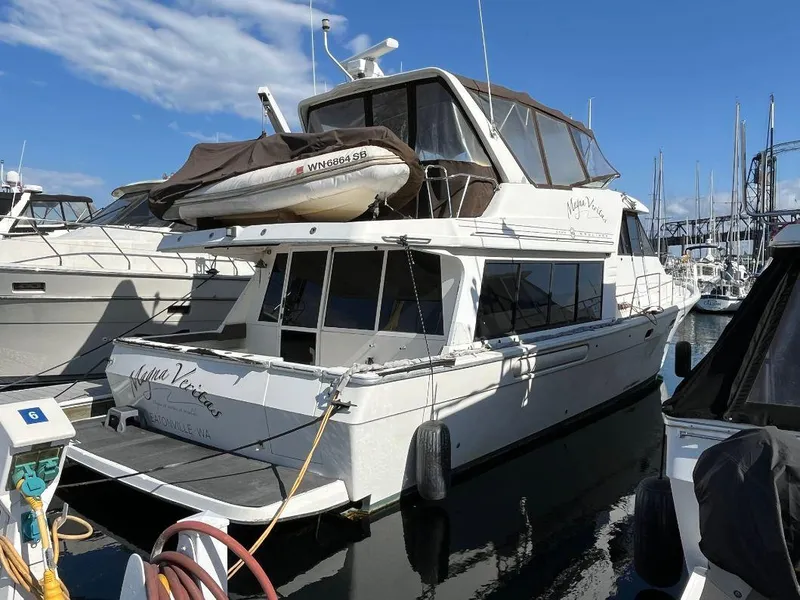 Slide: The Image of 1996 Bayliner 4788 yacht docked at marina under clear blue sky. - 9