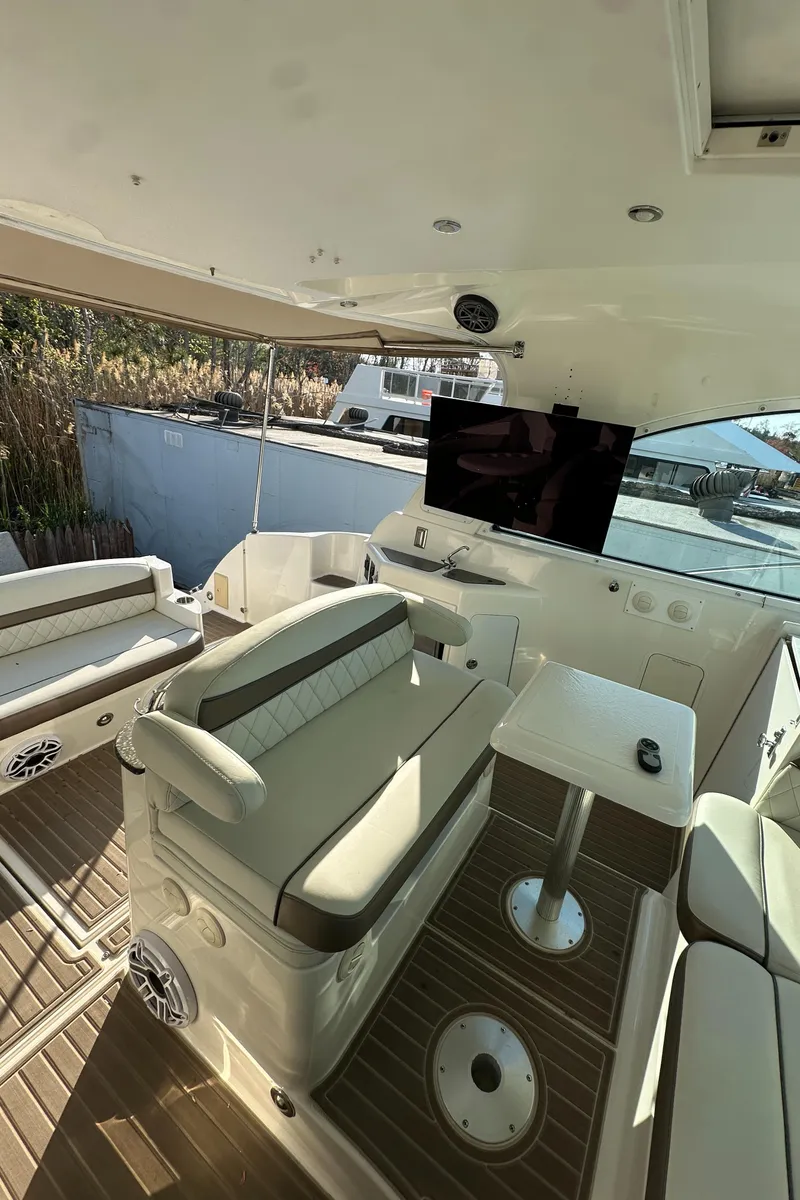 Slide: The Image of 2007 Cruisers 390 Sport Coupe interior with seating, table, and TV. - 13
