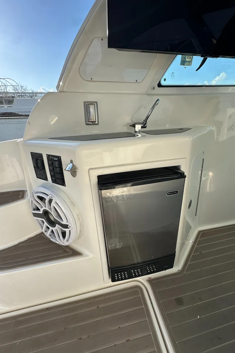 Slide: The Image of 2007 Cruisers 390 Sport Coupe yacht interior with mini fridge and sink. - 17