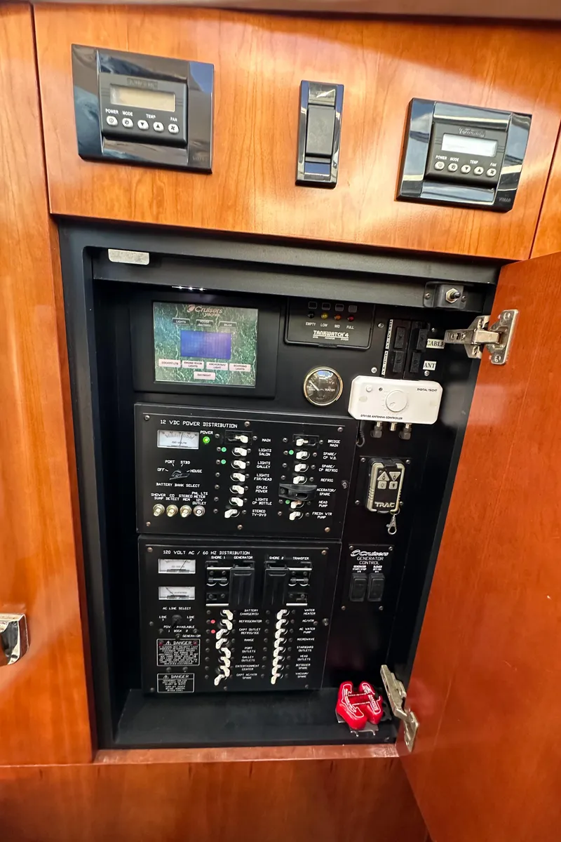 Slide: The Image of Electrical control panel in 2007 Cruisers 390 Sport Coupe yacht, featuring various switches and displays. - 19