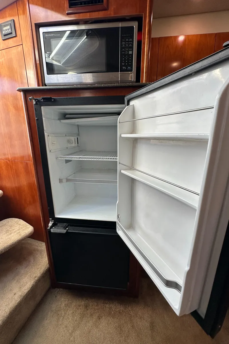 Slide: The Image of 2007 Cruisers 390 Sport Coupe kitchen with open fridge and microwave. - 21