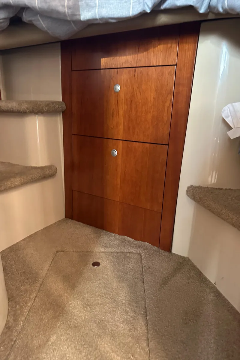 Slide: The Image of Interior of 2007 Cruisers 390 Sport Coupe with wooden cabinetry and carpeted steps. - 23