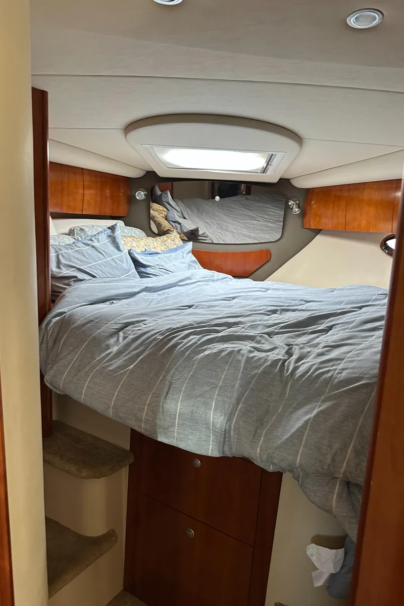 Slide: The Image of Interior cabin of 2007 Cruisers 390 Sport Coupe with cozy bed and wooden accents. - 24