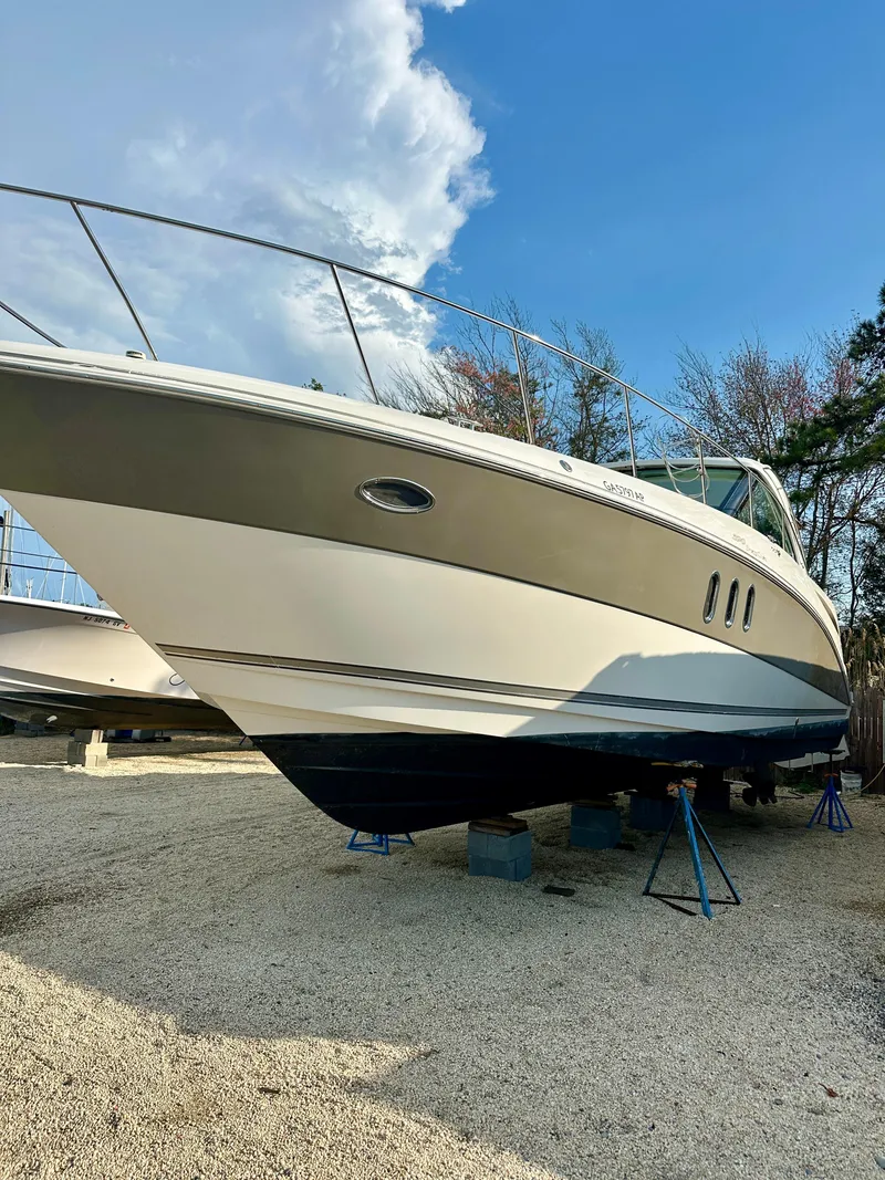 Slide: The Image of 2007 Cruisers 390 Sport Coupe boat on stands, clear sky background. - 3