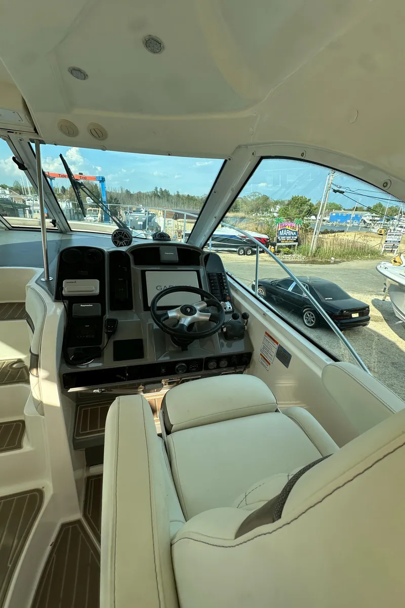 Slide: The Image of 2007 Cruisers 390 Sport Coupe helm with modern controls and panoramic windows. - 7