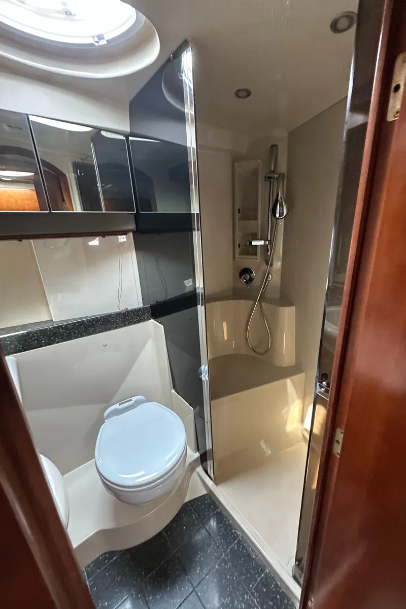 Slide: The Image of 2007 Cruisers 390 Sport Coupe kitchen with wood cabinets, black countertops, and stainless steel sink. - 8